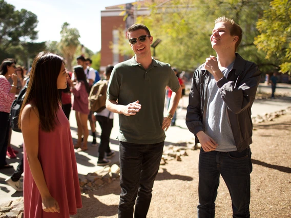 Students standing and talking outside Old Main.